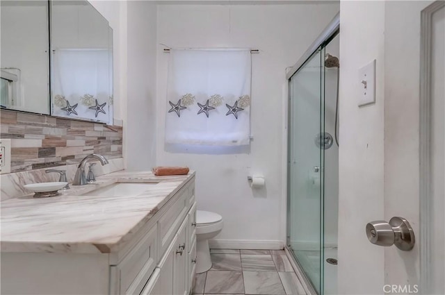 full bathroom featuring vanity, baseboards, backsplash, toilet, and a shower stall
