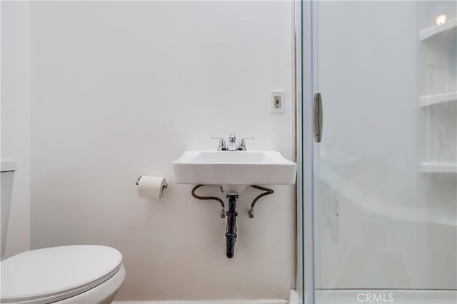 full bath with toilet and a shower stall