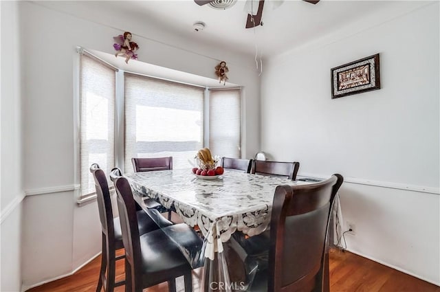 dining space with wood finished floors and ceiling fan
