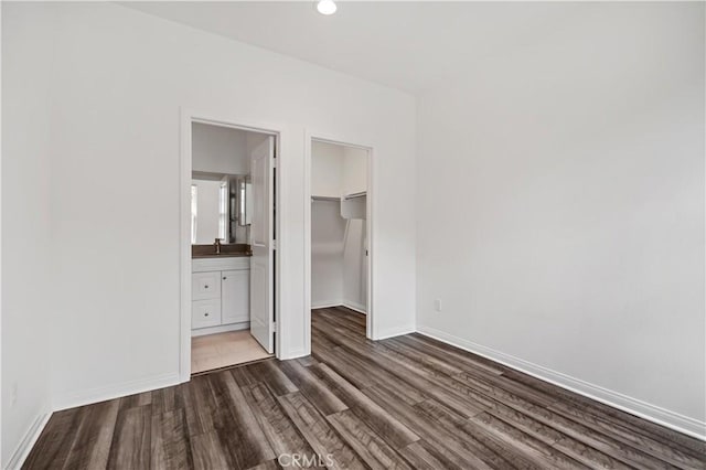 6991 Cottonwood Ln, Buena Park, CA 90621 - unfurnished bedroom featuring dark wood-style floors, a spacious closet, a closet, ensuite bath, and recessed lighting