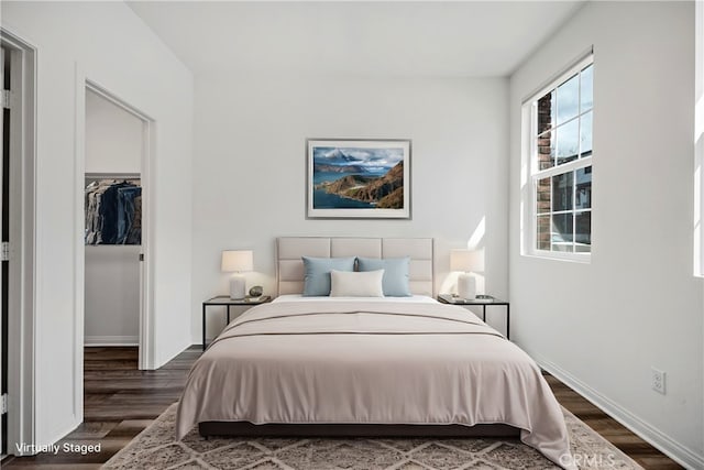 6991 Cottonwood Ln, Buena Park, CA 90621 - bedroom with dark wood-style flooring, a walk in closet, and a closet