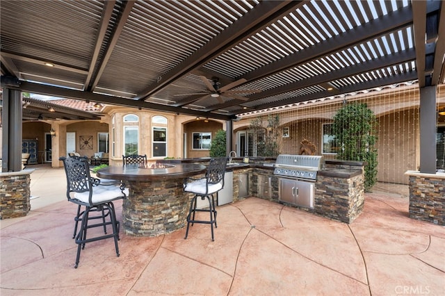 view of patio / terrace with exterior kitchen, a pergola, area for grilling, and outdoor wet bar