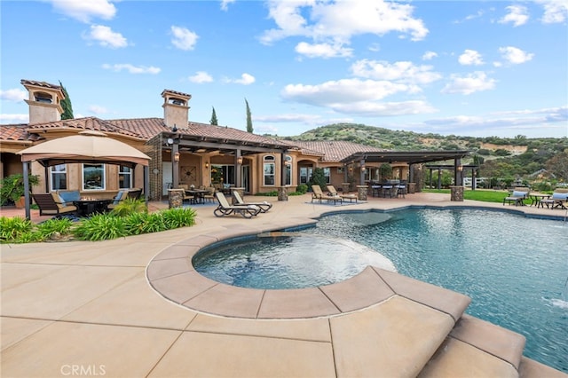 pool with a patio area and outdoor dining area