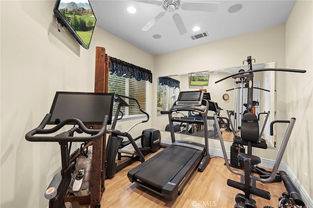 workout room with visible vents, ceiling fan, baseboards, and wood finished floors