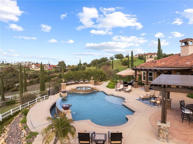 view of swimming pool with a patio area, a gazebo, fence, and a pool with connected hot tub