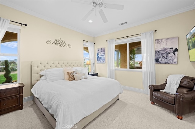 carpeted bedroom featuring multiple windows, baseboards, and crown molding