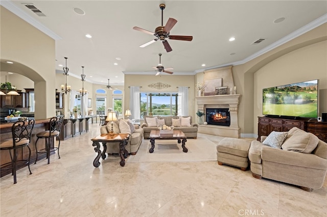 living room with ornamental molding, recessed lighting, a fireplace, visible vents, and ceiling fan
