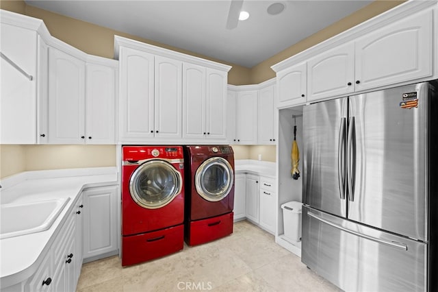 washroom with independent washer and dryer, a sink, and cabinet space