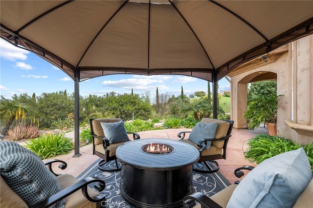 view of patio / terrace featuring a fire pit and a gazebo