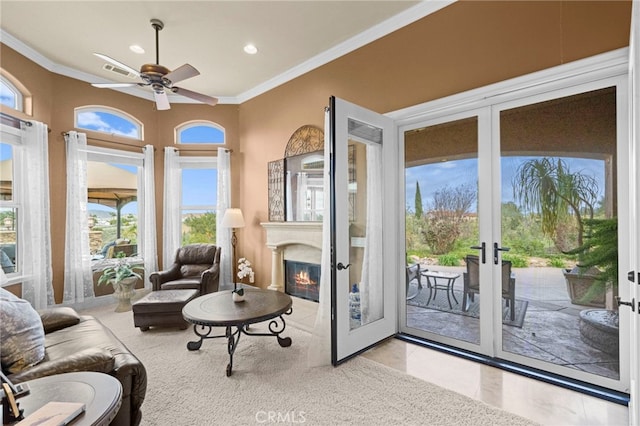 interior space featuring a wealth of natural light, french doors, crown molding, and a ceiling fan