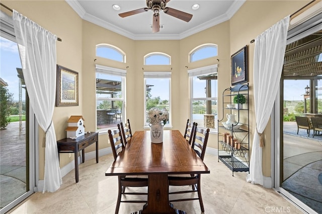 dining space with crown molding, baseboards, a ceiling fan, and light tile patterned floors