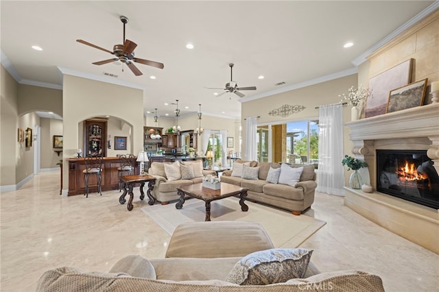 living area with marble finish floor, arched walkways, visible vents, and recessed lighting