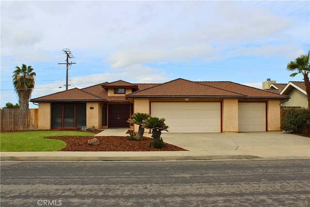 216 Palm Ct, Hanford, CA 93230 - view of front facade featuring fence, stucco siding, a garage, and concrete driveway