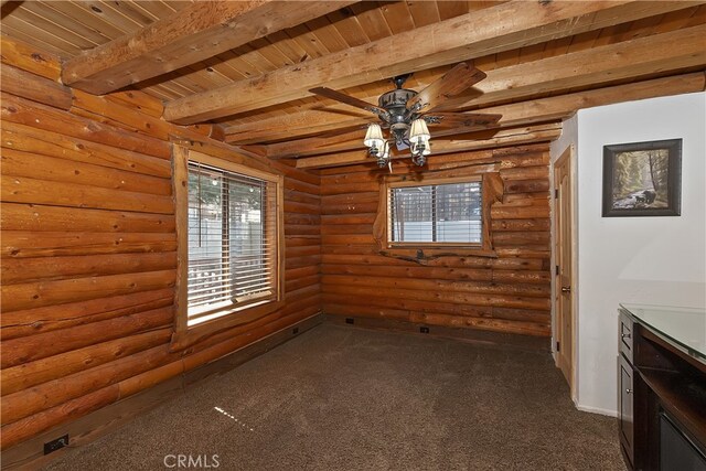 2424 Spruce Dr, Running Springs, CA 92382 - unfurnished dining area featuring dark carpet, a wooden ceiling with exposed beams, a ceiling fan, and rustic walls