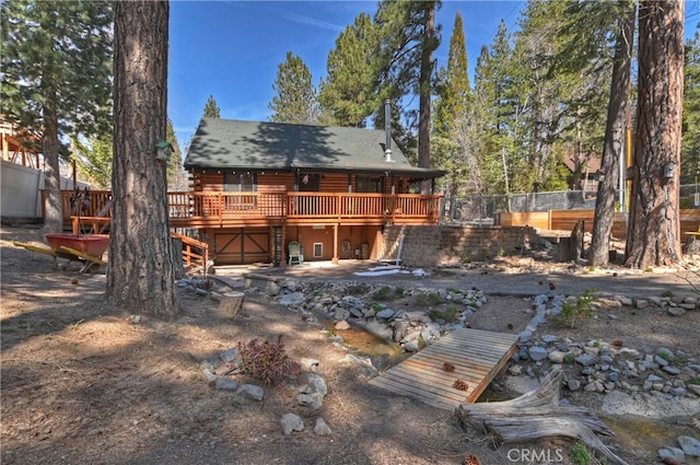 2424 Spruce Dr, Running Springs, CA 92382 - back of property with a deck, log exterior, and a shingled roof