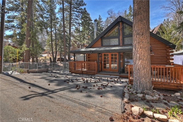 2424 Spruce Dr, Running Springs, CA 92382 - back of property with log exterior, a wooden deck, and french doors