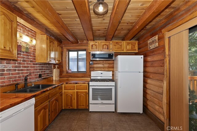 2424 Spruce Dr, Running Springs, CA 92382 - kitchen with white appliances, log walls, a wooden ceiling with exposed beams, healthy amount of natural light, and dark tile patterned flooring
