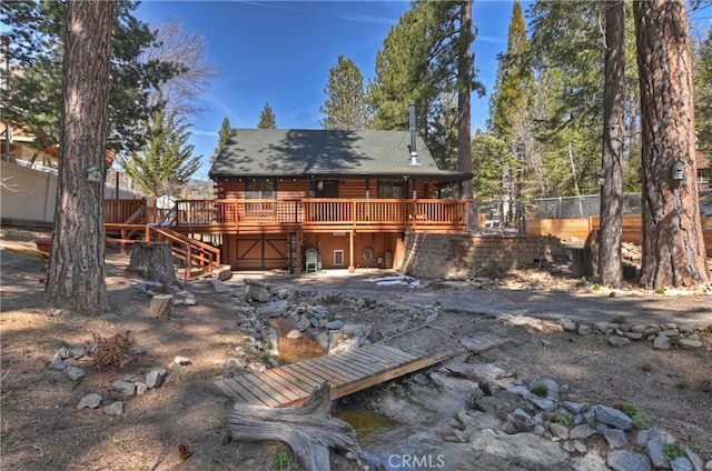 2424 Spruce Dr, Running Springs, CA 92382 - rear view of property with log exterior, a wooden deck, and stairway