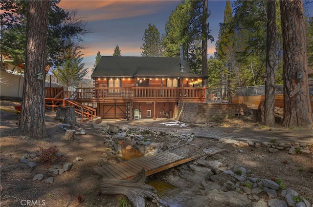 2424 Spruce Dr, Running Springs, CA 92382 - back of property at dusk featuring a wooden deck, log exterior, and stairs
