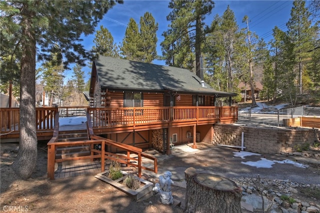 2424 Spruce Dr, Running Springs, CA 92382 - back of house with a deck, log siding, roof with shingles, a patio area, and stairway