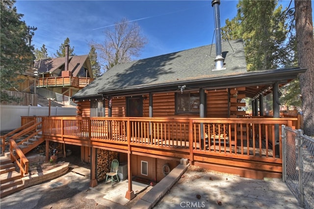 2424 Spruce Dr, Running Springs, CA 92382 - back of property featuring log exterior, roof with shingles, a patio area, and a deck
