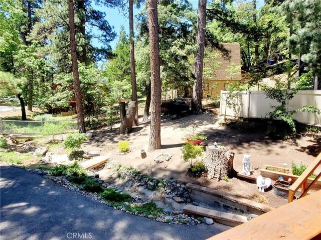 2424 Spruce Dr, Running Springs, CA 92382 - view of yard with view of wooded area
