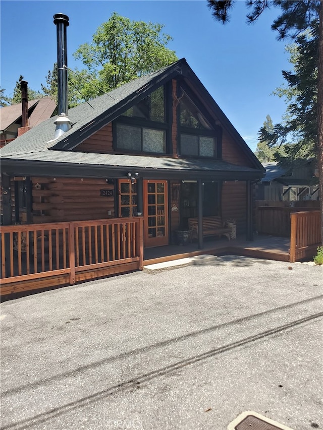 2424 Spruce Dr, Running Springs, CA 92382 - back of house featuring covered porch and log exterior