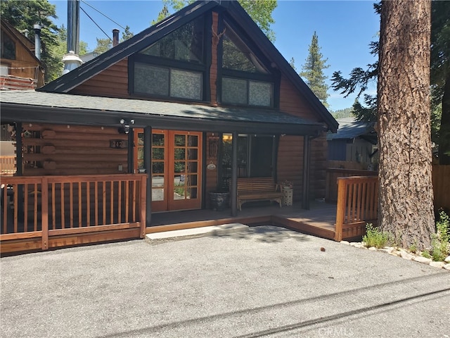 2424 Spruce Dr, Running Springs, CA 92382 - back of house with french doors, log exterior, and a shingled roof