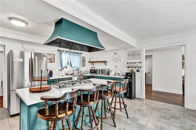 kitchen featuring custom exhaust hood, freestanding refrigerator, and crown molding