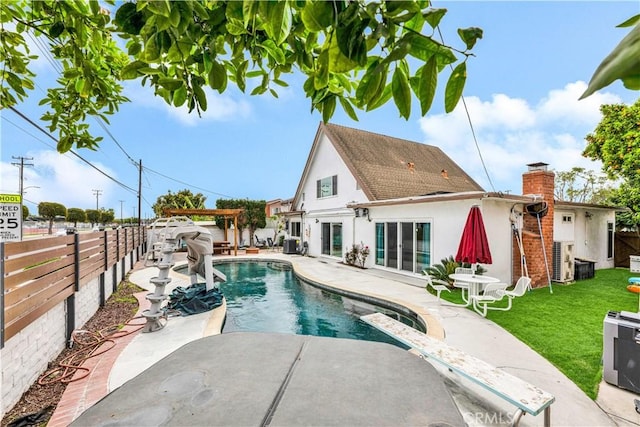 view of swimming pool featuring a patio area, a fenced backyard, a fenced in pool, and a lawn