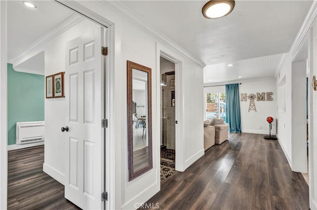 hallway with dark wood-type flooring, crown molding, baseboards, and heating unit