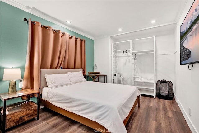 bedroom featuring recessed lighting, ornamental molding, and wood finished floors