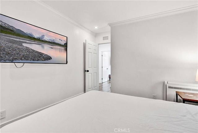 bedroom featuring visible vents, crown molding, recessed lighting, radiator, and wood finished floors