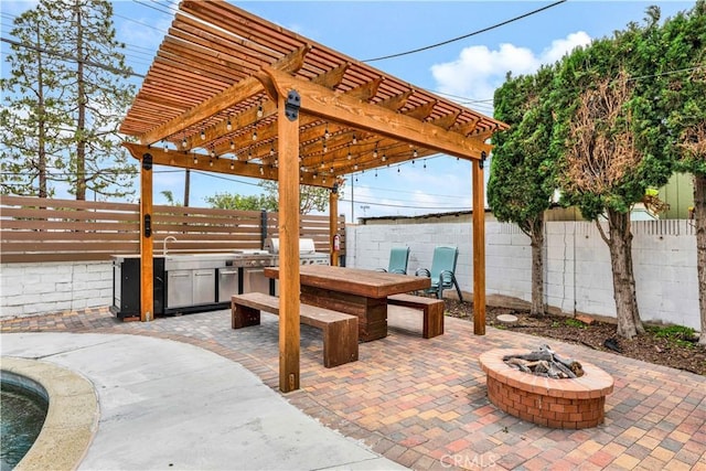 view of patio / terrace with a fenced backyard, a fire pit, grilling area, and a pergola