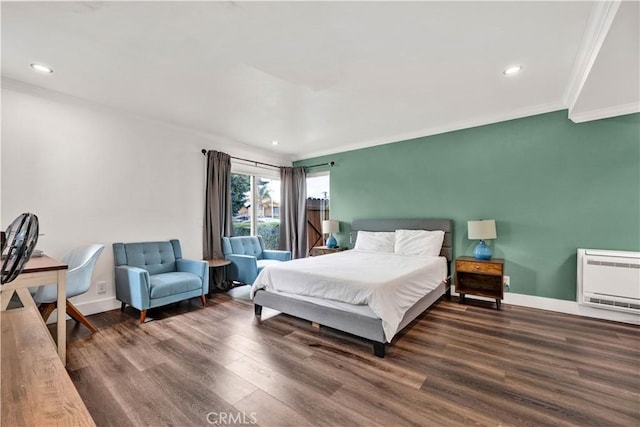 bedroom with ornamental molding, recessed lighting, wood finished floors, baseboards, and heating unit