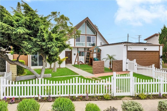 view of front of house with stucco siding, a gate, an attached garage, a front yard, and fence