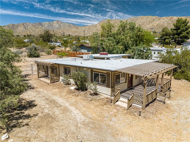 rear view of house featuring a mountain view
