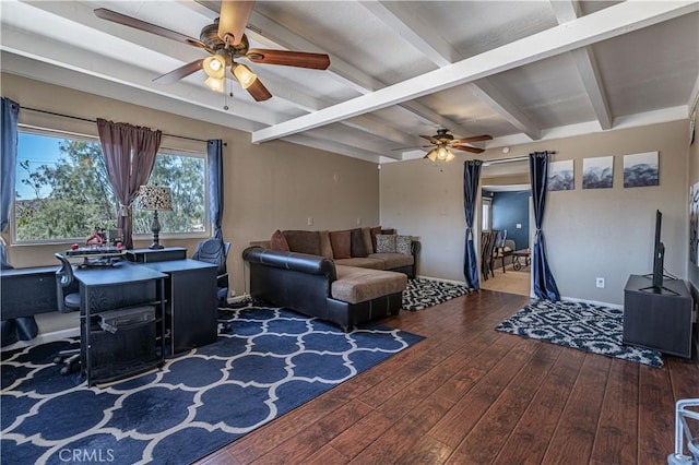 living area with hardwood / wood-style floors, a ceiling fan, and beam ceiling