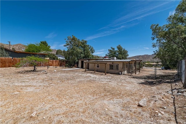 view of yard with a mountain view and fence