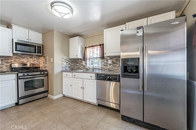 kitchen with white cabinetry, light tile patterned floors, a sink, and stainless steel appliances