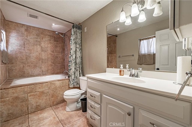 bathroom featuring a textured wall, visible vents, tiled shower / bath combo, and tile patterned flooring