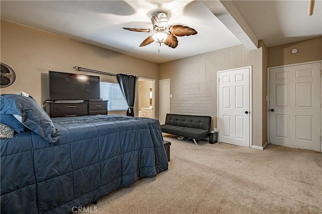 bedroom with carpet floors, connected bathroom, and ceiling fan