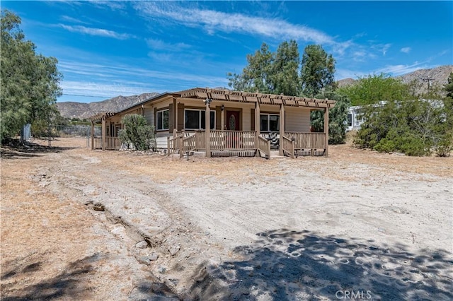 view of front of property featuring a deck with mountain view