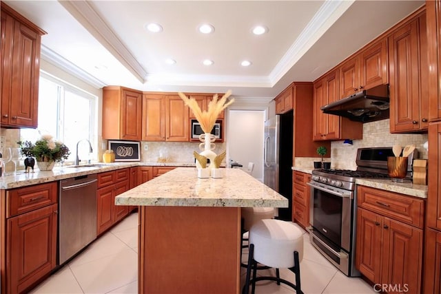 1971 Via Tranquilo, Rowland Heights, CA 91748 - kitchen with stainless steel appliances, under cabinet range hood, a center island, a breakfast bar, and crown molding