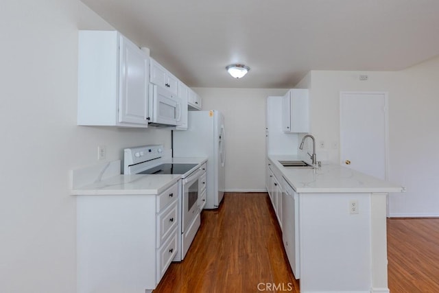23222 Orange Ave Unit 4, Lake Forest, CA 92630 - kitchen featuring dark wood-type flooring, white appliances, a sink, and a peninsula