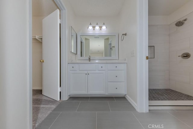23222 Orange Ave Unit 4, Lake Forest, CA 92630 - bathroom with tile patterned flooring, vanity, and a tile shower