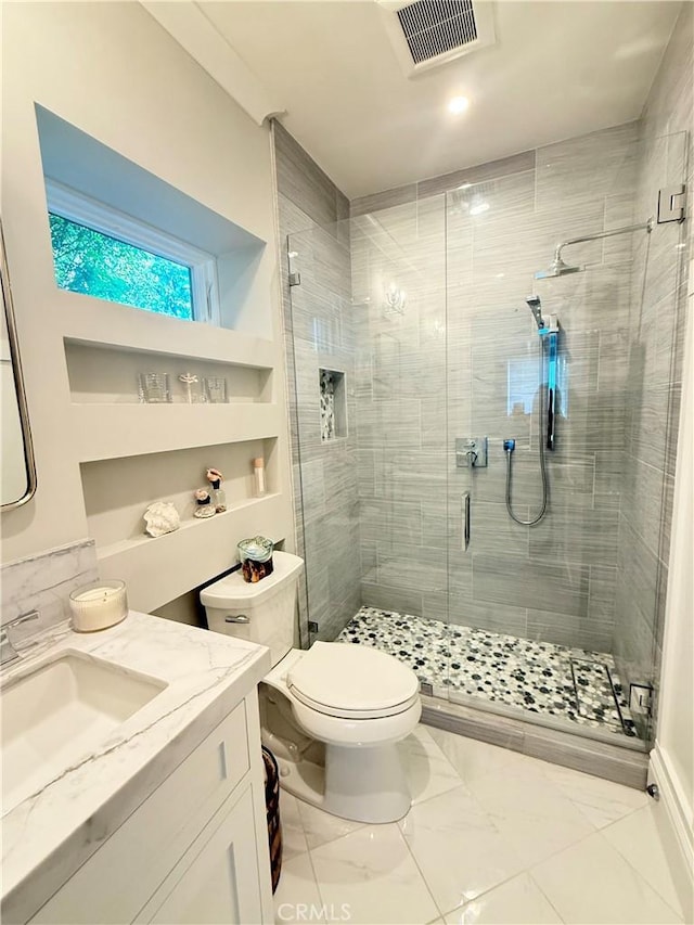 bathroom with toilet, a stall shower, marble finish floor, and visible vents