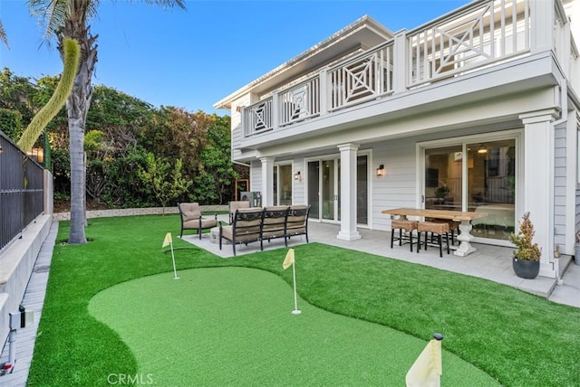 66 S La Senda Dr, Laguna Beach, CA 92651 - back of house featuring a balcony, a patio, a fenced backyard, an outdoor hangout area, and a lawn