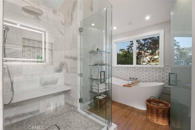 66 S La Senda Dr, Laguna Beach, CA 92651 - bathroom featuring plenty of natural light, a freestanding tub, tile walls, a stall shower, and hardwood / wood-style floors
