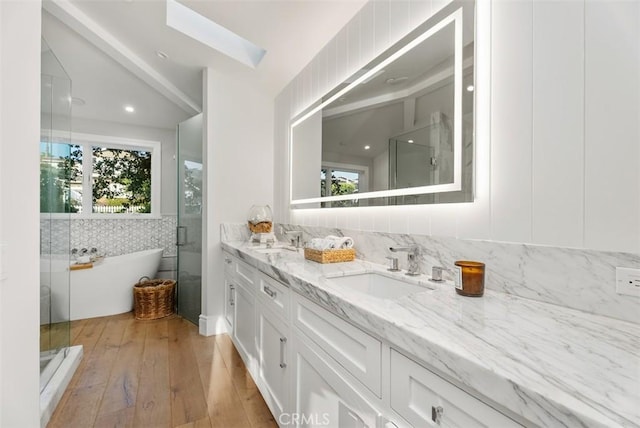 66 S La Senda Dr, Laguna Beach, CA 92651 - full bath with a sink, wood-type flooring, a shower stall, and double vanity